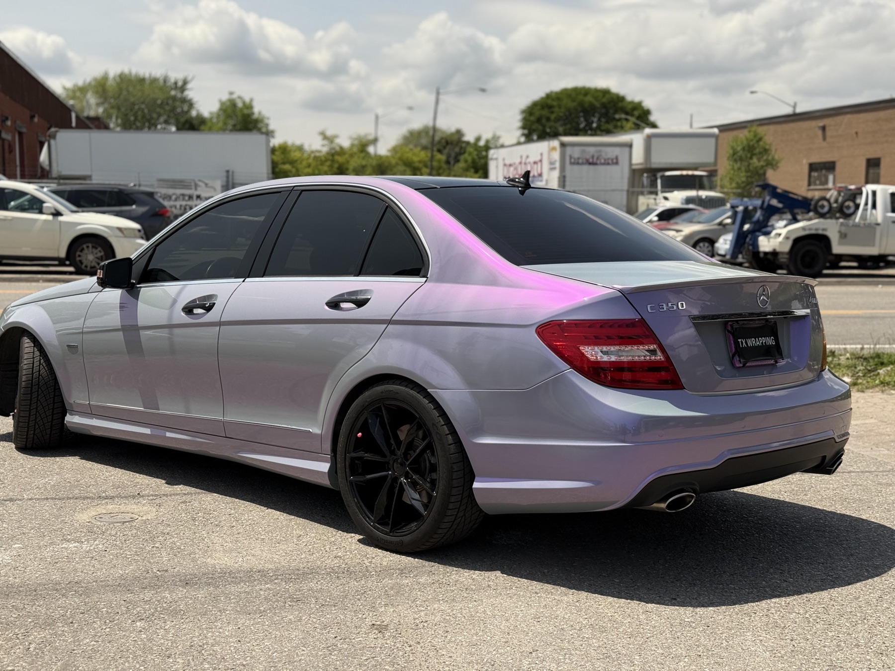 Satin color-shifting vinyl wrap on a luxury sedan